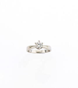 RINGS: 0.50 carat solitaire diamond ring and a pave diamond band ring. 18ct white and yellow gold. 7.71 grams.