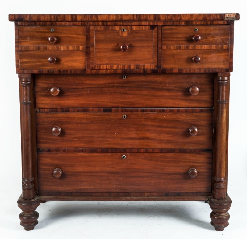 An antique Australian cedar cantilevered chest of drawers with turned columns and cross banded edges, full cedar construction, Sydney origin, circa 1850, 125cm high, 125cm wide, 61cm deep