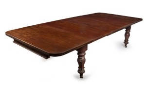A fine antique English mahogany three leaf extension dining table with inverted baluster lotus turned leg with original brass casters, circa 1850, 72cm high, 134cm wide (extends to 297cm), 137cm deep