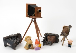 VARIOUS MANUFACTURERS: Seven decorative items - one approx. 12x8x34cm replica of early wooden plate camera, three approx. 8x10x12cm painted ceramic camera sculptures, and three small figurines each with camera in hand. (7 items)