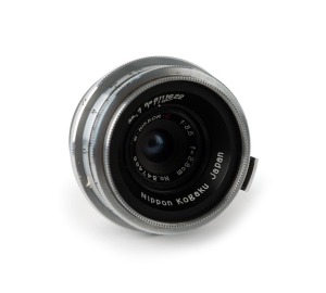 NIPPON KOGAKU: Type 1 W-Nikkor·C 28mm f3.5 lens [#347466] with bayonet mount in chrome, c. 1952, with rear lens cap. First series model with decreasing diaphragm scale.
