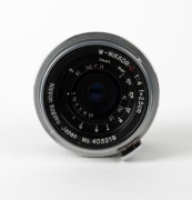 NIPPON KOGAKU: W-Nikkor&middot;C&nbsp;25mm f4 lens [#403219]&nbsp;with bayonet mount&nbsp;in chrome, c. 1953, together with metal rear lens cap. - 2