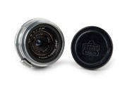NIPPON KOGAKU: W-Nikkor&middot;C&nbsp;28mm f3.5 lens [#712671]&nbsp;for rangefinder cameras with Nikon-S mount&nbsp;in chrome, c. 1954, together with metal front and rear lens caps. Second series with equidistant scale markings.