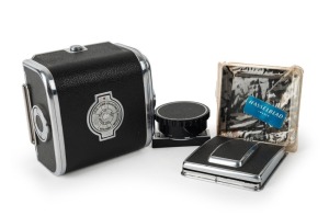 HASSELBLAD: Four camera accessories - one 1952 black and chrome 1600F camera back [#CH 14224], two waist-level viewfinders in black and chrome, and one film winding knob for C models. (4 items)