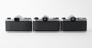 ASAHI KOGAKU: Three circa 1960 chrome-body SLR cameras - one Pentax S2 [#326638] with Auto-Takumar 55mm f2 lens [#376835], one Pentax H2 [#230641] with Auto-Takumar 55mm f2 lens [#264636] and front lens cap, and one Pentax SV [#930754] with Super-Takumar - 3