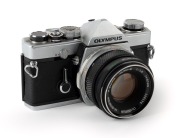 OLYMPUS: 1972 chrome-body Olympus M-1 SLR camera [#135685] with M-System Auto-S 50mm f1.8 lens [#125174]. Very few of these cameras and lenses were produced before name was&nbsp;changed to 'OM-1' to avoid infringing on the Leitz&nbsp;M1 trademark.