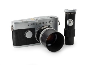 OLYMPUS: Pen FT half-frame SLR camera [#292237], c. 1966, with G. Zuiko Auto-S 40mm f1.4 lens [#165272], T-45 metal lens hood, and Pen-F straight magnifier viewfinder attachment.