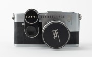 OLYMPUS: Pen F SLR camera [#149540], c. 1963, with G. Zuiko Auto-S 40mm f1.4 lens [#189994] and ASA exposure meter, together with metal front lens cap and two Vinson coated lens filters with designations 1A and UV. The world's first 35mm half-frame SLR. - 2