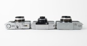 OLYMPUS: Three c. 1967 35mm half-frame cameras - one Pen-EM [#105763] with F. Zuiko 35mm f2 lens and Olympus 82C lens filter, one Pen Rapid-EE S [#100335] with D. Zuiko 30mm f2.8 lens and Olympus lens hood, and one Pen-EED [#251516] with F. Zuiko 32mm f1. - 4
