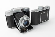 OLYMPUS: Two vertical-folding cameras - one 1948 Chrome Six I [#22296] with Zuiko 75mm f3.5 lens [#35225] and Copal shutter, and one 1955 Chrome Six Va&nbsp;[#172624] with D. Zuiko 75mm f3.5 lens [#140869] and Copal shutter. (2 cameras)