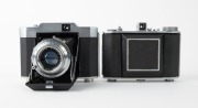 OLYMPUS: Two vertical-folding cameras - one 1948 Chrome Six I [#22296] with Zuiko 75mm f3.5 lens [#35225] and Copal shutter, and one 1955 Chrome Six Va&nbsp;[#172624] with D. Zuiko 75mm f3.5 lens [#140869] and Copal shutter. (2 cameras) - 2