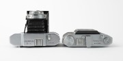 OLYMPUS: Two vertical-folding cameras - one 1948 Chrome Six I [#22296] with Zuiko 75mm f3.5 lens [#35225] and Copal shutter, and one 1955 Chrome Six Va&nbsp;[#172624] with D. Zuiko 75mm f3.5 lens [#140869] and Copal shutter. (2 cameras) - 4