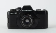 ASAHI KOGAKU: Circa 1979 Pentax Auto 110 SLR system, comprising one black-body Pentax Auto 110 camera [#1287212] with Pentax-110 24mm f2.8 lens [#1273437] and front lens cap, two additional lenses with front and rear lens caps, AF130P flash unit, 110 Wind - 3