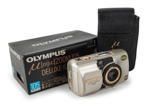 OLYMPUS: Mju Zoom 105 Deluxe L compact camera [#5796964] with gold body and lens detail, c. 1995, with Zoom 38-105mm lens, in maker's box with leatherette pouch, RC-200 remote control, wrist strap, and instruction booklet.
