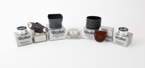 FRANKE & HEIDECKE: Seven Rollei accessories in silver maker's boxes - one Rolleiflex Panoramakopf [#458134], one Rolleinar 1 and one Rolleinar 2 with leather pouches and instruction sheets, one Rolleisoft 0 with leather pouch and instruction sheet, one Fi