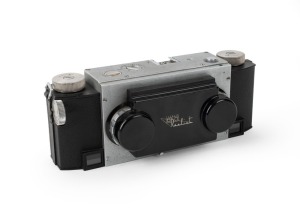 WHITE: Stereo Realist Model 1041 stereo camera [#A69780], c. 1947, with dual f3.5 lenses. Unusual design with viewfinder at bottom of camera and integrated flip-up lens cap.