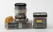 CANON: Transparent-body Canon EOS 650, c. 1987, with EF Zoom 35-105mm f3.5-4.5 lens, 420EZ battery-operated flash unit [#F055E], and rubber eyepiece attachment. Intended as a sales aid to illustrate the advantages of the EOS 650 to potential buyers. - 4