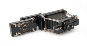 HOUGHTON: Three black strut-folding cameras - one pre-1911 Ensignette No. 1 with 'N-sign' engraving, one post-1911 Ensignette No. 1 with embossed patent details and flag logo, and one Ensignette No. 2 D De Luxe, with Aldis-Plano Anastigmat f6.5 lens. (3 cameras)