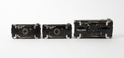 HOUGHTON: Three black strut-folding cameras - one pre-1911 Ensignette No. 1 with 'N-sign' engraving, one post-1911 Ensignette No. 1 with embossed patent details and flag logo, and one Ensignette No. 2 D De Luxe, with&nbsp;Aldis-Plano Anastigmat f6.5 lens. (3 c - 2
