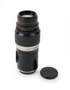 LEITZ: Screw-mount c. 1930s Elmar 135mm f4.5 lens, in black and chrome, with front and rear caps. Very early lens bearing no serial number.