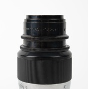 LEITZ: Screw-mount c. 1930s Elmar 135mm f4.5 lens, in black and chrome, with front and rear caps. Very early lens bearing no serial number. - 2