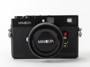 MINOLTA: Black-body Minolta CLE rangefinder camera [#1026865], c. 1981, with M-Rokkor 40mm f2 lens [#2113964], together with front lens cap, Minolta rubber lens hood, and Minolta Auto CLE flash unit in leatherette case. Produced in partnership with Leica. - 2