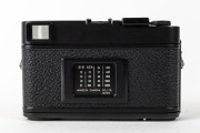MINOLTA: Black-body Minolta CLE rangefinder camera [#1026865], c. 1981, with M-Rokkor 40mm f2 lens [#2113964], together with front lens cap, Minolta rubber lens hood, and Minolta Auto CLE flash unit in leatherette case. Produced in partnership with Leica. - 3