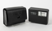 MINOLTA: Black-body Minolta CLE rangefinder camera [#1026865], c. 1981, with M-Rokkor 40mm f2 lens [#2113964], together with front lens cap, Minolta rubber lens hood, and Minolta Auto CLE flash unit in leatherette case. Produced in partnership with Leica. - 6