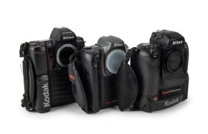 NIPPON KOGAKU: Three c. 1990s Nikon SLR camera bodies with Kodak digital camera backs - one Nikon F5 with body cap coupled to Kodak DCS 760 [#K760C-04198], one Nikon F-801s coupled to Kodak DCS 200 [#K380-8137], and one Nikon Pronea 6i with body cap coupl