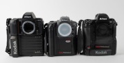 NIPPON KOGAKU: Three c. 1990s Nikon SLR camera bodies with Kodak digital camera backs - one Nikon F5 with body cap coupled to Kodak DCS 760 [#K760C-04198], one Nikon F-801s coupled to Kodak DCS 200 [#K380-8137], and one Nikon Pronea 6i with body cap coupl - 2