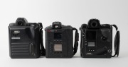 NIPPON KOGAKU: Three c. 1990s Nikon SLR camera bodies with Kodak digital camera backs - one Nikon F5 with body cap coupled to Kodak DCS 760 [#K760C-04198], one Nikon F-801s coupled to Kodak DCS 200 [#K380-8137], and one Nikon Pronea 6i with body cap coupl - 3