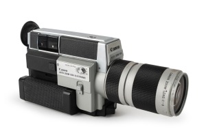 CANON: Circa 1973 Canon Auto Zoom 1014 Electronic 8mm movie camera [#160388], with Macro 7-70mm f1.4 lens [#164940], together with lens cap, wrist strap, remote switch, and leather case.