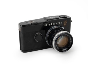 OLYMPUS: Rare black Pen F SLR camera [#211933], c. 1963, with G. Zuiko Auto-S 40mm f1.4 lens [#113850]. The world's first 35mm half-frame SLR.