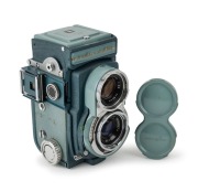 MINOLTA: 1959 Miniflex TLR camera [#105187], with Rokkor&nbsp;60mm f3.5 lens [#1103379], sportsfinder&nbsp;attachment, and lens cap. One of fewer than 5000 produced.