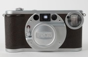 MINOLTA: Minolta Prod-20's retro-design 35mm compact camera [#33865], c. 1990, with Minolta 35mm f4.5 lens and metal lens cap. Maker's box with suede pouch, wrist strap, and printed matter also present. - 2