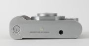 MINOLTA: Minolta Prod-20's retro-design 35mm compact camera [#33865], c. 1990, with Minolta 35mm f4.5 lens and metal lens cap. Maker's box with suede pouch, wrist strap, and printed matter also present. - 5