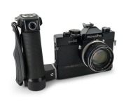 MINOLTA: Black-body Minolta SR-M SLR camera [#1002391], c. 1970, with MC Rokkor-PF&nbsp;55mm f1.7 lens [#2478516] and hand grip attachment. The first 35mm SLR with integrated motor built into the body.