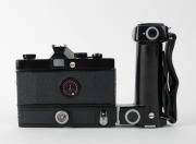 MINOLTA: Black-body Minolta SR-M SLR camera [#1002391], c. 1970, with MC Rokkor-PF&nbsp;55mm f1.7 lens [#2478516] and hand grip attachment. The first 35mm SLR with integrated motor built into the body. - 3
