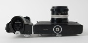 MINOLTA: Black-body Minolta SR-M SLR camera [#1002391], c. 1970, with MC Rokkor-PF&nbsp;55mm f1.7 lens [#2478516] and hand grip attachment. The first 35mm SLR with integrated motor built into the body. - 5