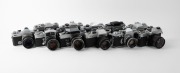 VARIOUS MANUFACTURERS: Eleven black-and-chrome SLR cameras - one&nbsp;Foto-Quelle&nbsp;Revueflex SL 301, one Ihagee Exakta RTL 1000, one Kamera Werkst&auml;tten&nbsp;Praktica VLC2, one Mamiya/Sekor 500 DTL, one Minolta SR-1 with front lens cap, one Minolta SRT-101 with front