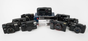 VARIOUS MANUFACTURERS: Nine black plastic compact cameras - one Hanimex 35 MAF, one Minolta AF-Sv with wrist strap, one Minolta AF-Tele Super with wrist strap, one Minolta Hi-Matic AF2-M with lens cap, one Minolta Hi-Matic 5, one Minolta Hi-Matic SD, one 