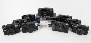 VARIOUS MANUFACTURERS: Nine black plastic compact cameras - one Hanimex 35 MAF, one Minolta AF-Sv with wrist strap, one Minolta AF-Tele Super with wrist strap, one Minolta Hi-Matic AF2-M with lens cap, one Minolta Hi-Matic 5, one Minolta Hi-Matic SD, one Nova 35MD, one Ricoh RZ-800 Date in maker's box with printed matter, and one Vivitar TW35 with wrist strap. (9 cameras)