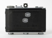 OLYMPUS: Chrome Six II vertical-folding camera [#34865], c. 1948, with Zuiko Coated 75mm f2.8 lens [#59760] and Copal lens. Presented with leather case in maker's wooden box that features etched text&nbsp;on lid. - 3