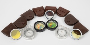 FRANKE & HEIDECKE: Twelve lens filters in either leather maker's pouches or plastic cases, including lenses with Rolleinar 1, Rolleinar 2, BAEEN, BAIHE, BAIMI, BALIN, and BAUBI designations, among others. (12 items)