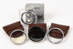 FRANKE & HEIDECKE: Four lens filters, three in leather maker's pouches and one in maker's box with plastic case and instruction sheet - one Rolleipol RIII -1.5 (blue), one CEIHE (light yellow), one CESKY (UV), and one CETNU (Rolleisoft 0). (4 items)