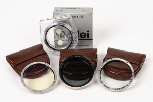 FRANKE & HEIDECKE: Four lens filters, three in leather maker's pouches and one in maker's box with plastic case and instruction sheet - one Rolleipol RIII -1.5 (blue), one CEIHE (light yellow), one CESKY (UV), and one CETNU (Rolleisoft 0). (4 items)