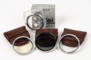 FRANKE & HEIDECKE: Four lens filters,&nbsp;three in leather maker's pouches and one in maker's box with plastic case and instruction sheet - one Rolleipol RIII -1.5 (blue), one&nbsp;CEIHE&nbsp;(light yellow), one CESKY&nbsp;(UV), and one CETNU (Rolleisoft 0). (4 items)