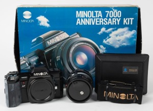 MINOLTA: Circa 1985 Minolta 7000 AF Anniversary Kit, comprising black camera body with body cap, black Minolta AF Zoom 35-70mm f4 lens with lens hood and front and rear caps, lens cleaning set, and black Minolta 60th Anniversary carry strap, neatly organi