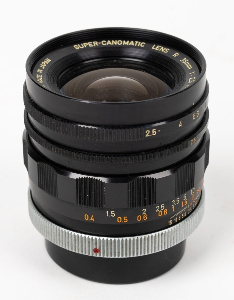 CANON: Black Super-Canomatic R 35mm f2.5 lens [#11990], c. 1961, with  bayonet mount for Canonflex SLR cameras, together with rear lens cap.