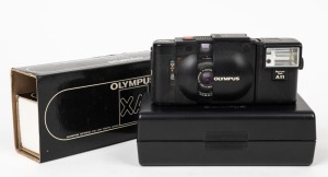 OLYMPUS: Circa 1979 black Olympus XA [#1262307] with attached A11 Electronic Flash, in maker's box with plastic case.